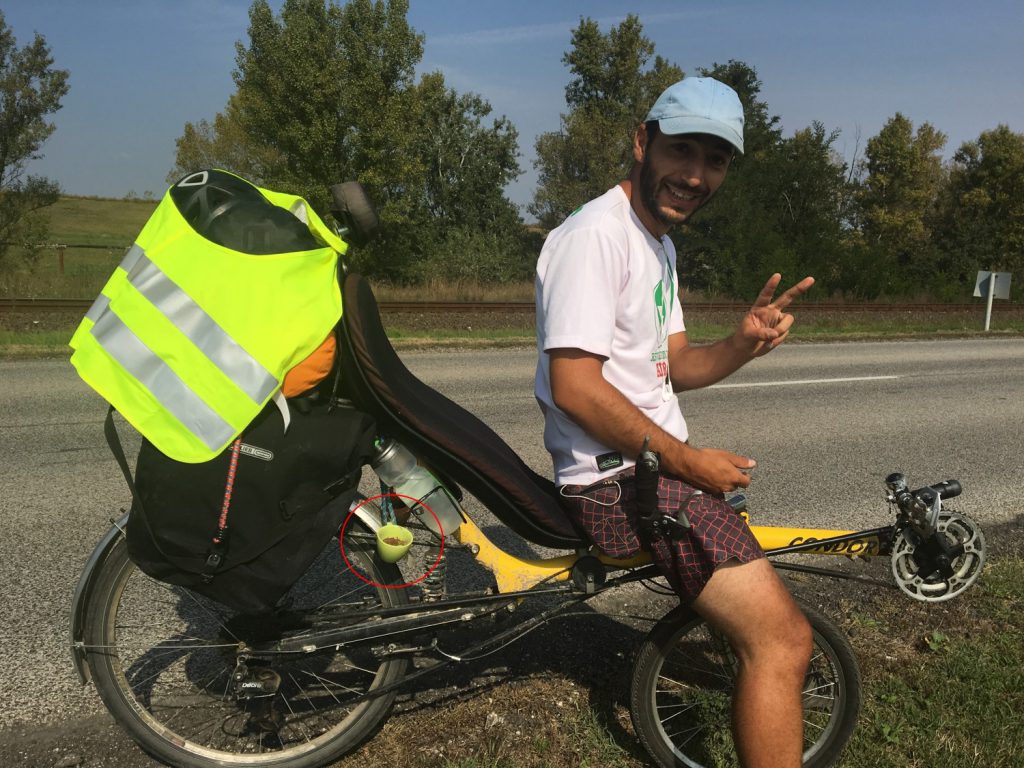 A man cycling with a garden.